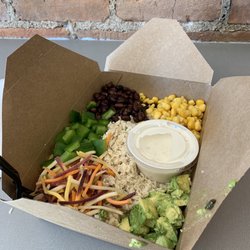 Outside The Box Wellness Cafe - Bowl with rice, chicken, corn, black beans, avocado, carrots, green pepper, and vegan ranch.