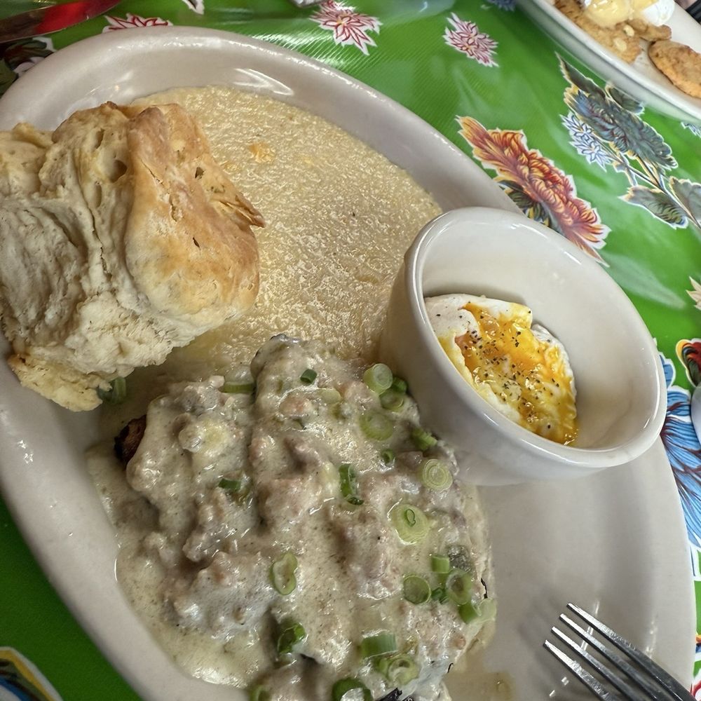 Elizabeth's Restaurant - Smoked smothered pork chop with poached eggs, grits and a biscuit. It was absolutely amazing!! - Southern Near Me - New Orleans, Louisiana Elizabeth's Restaurant - Smoked smothered pork chop with poached eggs, grits and a biscuit. It was absolutely amazing!! - Southern Near Me - New Orleans, Louisiana