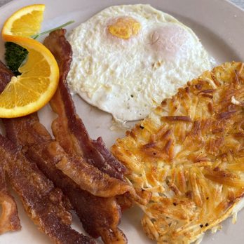 The Palms Cafe - 2 Eggs & Bacon breakfast with hashbrowns and a side pancake ($15.45). Eggs were supposed to be over easy. - Breakfast & Brunch Near Me - Rancho Mirage, California The Palms Cafe - 2 Eggs & Bacon breakfast with hashbrowns and a side pancake ($15.45). Eggs were supposed to be over easy. - Breakfast & Brunch Near Me - Rancho Mirage, California
