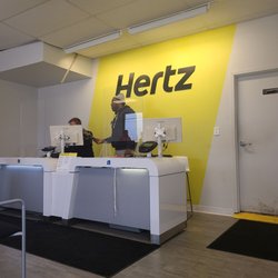 Hertz Rent A Car - They seem professional to me. Guys in the back also working hard.