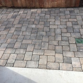 Red Dog Landscape - a brick paver patio with a wooden fence in the background - Landscaping Near Me Red Dog Landscape - a brick paver patio with a wooden fence in the background - Landscaping Near Me