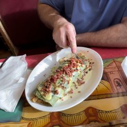 Casa Mexicana - Burrito Grande (spinach tortilla stuffed with shredded chicken & rice, topped with cheese sauce, homemade guacamole sauce and diced bacon)