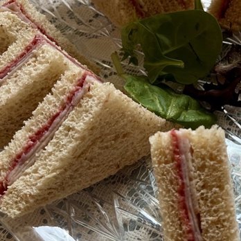 Lovey's Tea Shoppe - Turkey and cranberry tea sandwiches. The paper thin filling was so dull, the flavors were undetectable. - British Near Me - Pacifica, California