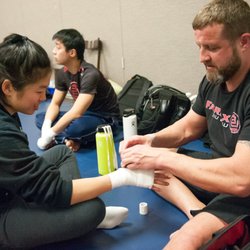 Fairfax Jiu Jitsu - Coach Matt wrapping hands before a fight.