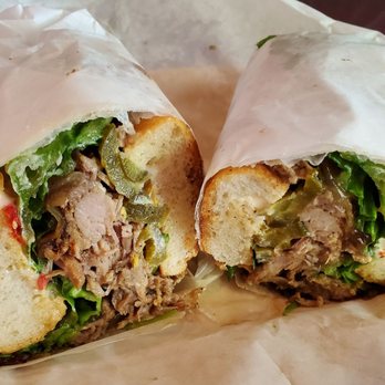 Paseo - #1 Famous Caribbean Roast: Marinated & slow roasted pork shoulder, fresh cilantro, pickled jalapenos, caramelized onions, crisp romaine - Caribbean Near Me - Seattle, Washington Paseo - #1 Famous Caribbean Roast: Marinated & slow roasted pork shoulder, fresh cilantro, pickled jalapenos, caramelized onions, crisp romaine - Caribbean Near Me - Seattle, Washington
