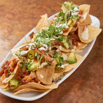 Secret Sauce - a plate of nachos on a table - Barbeque Near Me Secret Sauce - a plate of nachos on a table - Barbeque Near Me