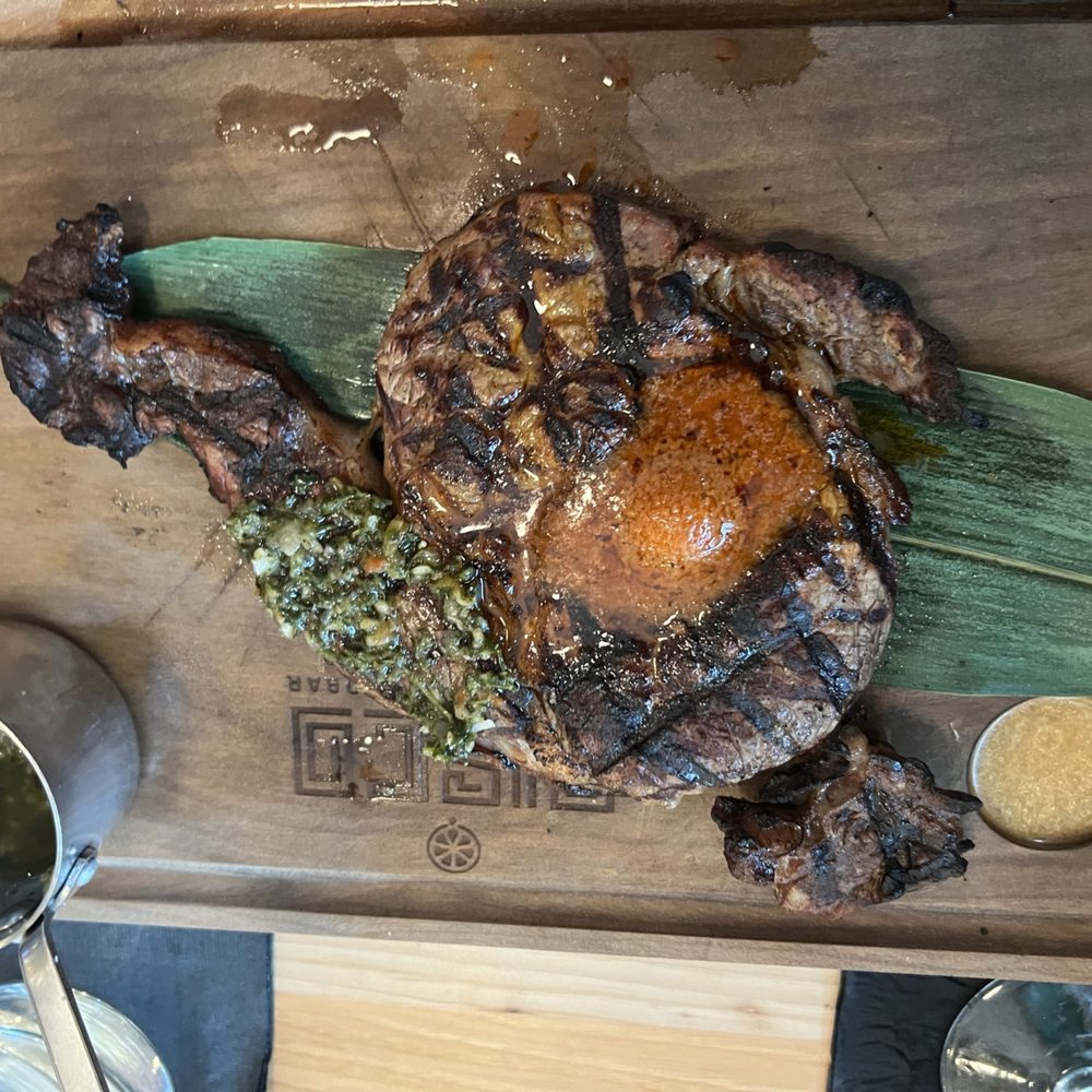 Pisco Peruvian Gastrobar - churrasco with butter (that they'll flamed upon serving it), and chimichurri. - Peruvian Near Me - Orlando, Florida