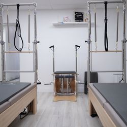 Pilates class studio with pilates reformer with tower mats