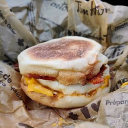 Bacon breakfast sandwich on an English muffin.