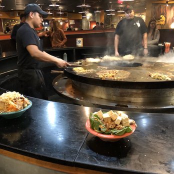 HuHot Mongolian Grill - a group of people preparing food - Asian Fusion Near Me - Manhattan, Kansas