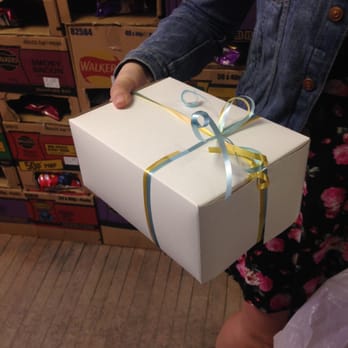 British Imports - a woman holding a white gift box - Grocery Near Me - Newmarket, Ontario British Imports - a woman holding a white gift box - Grocery Near Me - Newmarket, Ontario