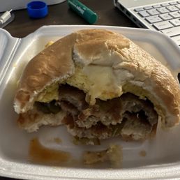 Breakfast sandwich being enjoyed Breakfast sandwich being enjoyed