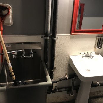 Broaster Kitchen - The crew leaves their dirty cleaning equipment inside the restroom. Even one map is standing up, waiting to fall on someone. - American Near Me - Montebello, California
