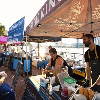 Sip & Stroll - a man serving food to a woman - Venues & Event Spaces Near Me - Jacksonville, Florida