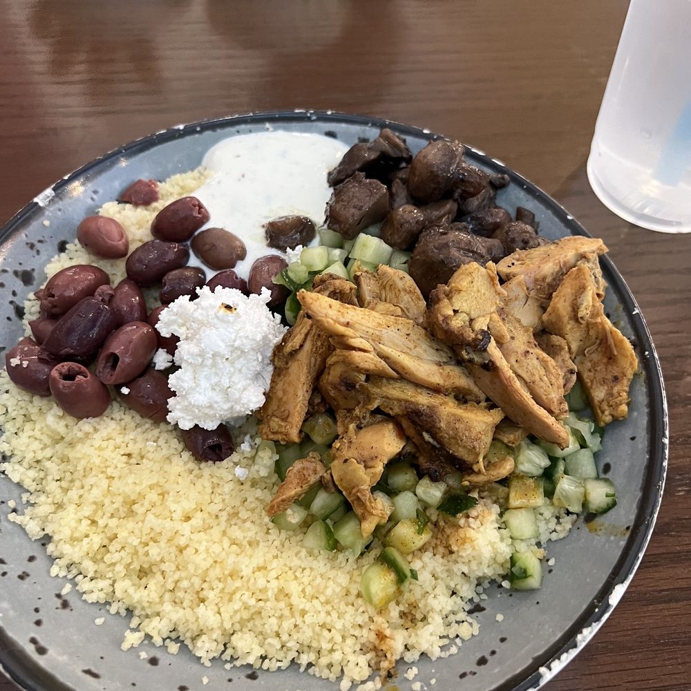 YAFO Kitchen - Build a bowl with couscous, cucumbers, pitted olives, feta, mushrooms and chicken. - Mediterranean Near Me - Charlotte, North Carolina