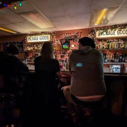 two people sitting at a bar two people sitting at a bar