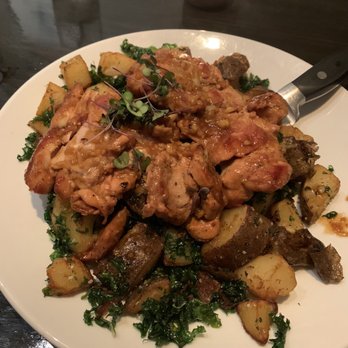 Iron Tail Tavern - Pan-seared chicken thighs over crispy kale and potatoes - Cocktail Bars Near Me - Buffalo, New York