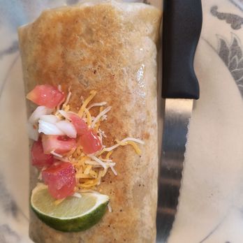 Candie's Crossties - a burrito on a plate with a knife - Tacos Near Me - Pittsburg, Texas Candie's Crossties - a burrito on a plate with a knife - Tacos Near Me - Pittsburg, Texas