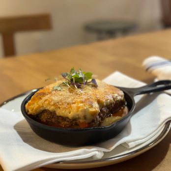 Simply Greek - a skillet of food on a wooden table - Greek Near Me - Brooklyn, New York