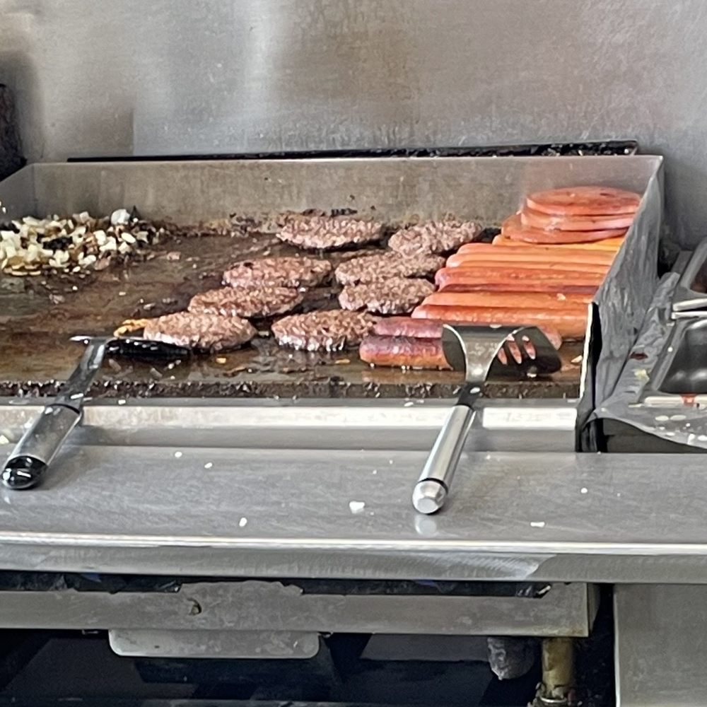 Burgers and dogs on the grill. Burgers and dogs on the grill.