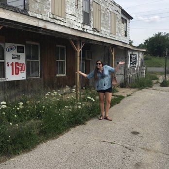 Wolverine Gardens - a woman standing in front of a building - Bars Near Me - Baroda, Michigan