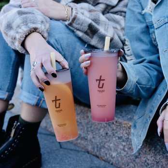 TBaar - Eagan - two women sitting on a curb with drinks - Bubble Tea Near Me - Eagan, Minnesota TBaar - Eagan - two women sitting on a curb with drinks - Bubble Tea Near Me - Eagan, Minnesota