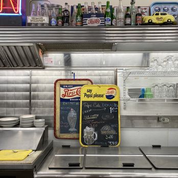 Laconia Antique Center - Antique soda bottles above the lunch counter with current menus on display - Antiques Near Me - Laconia, New Hampshire Laconia Antique Center - Antique soda bottles above the lunch counter with current menus on display - Antiques Near Me - Laconia, New Hampshire