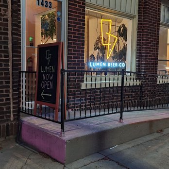 Lumen Beer - a neon sign in front of a brick building - Brewpubs Near Me - Omaha, Nebraska