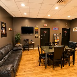 Cigar Box Premium Tobacconist - Inviting interior of Cigar Box featuring a comfortable customer lounge with seating, tables, premium cigar décor, and a clean...