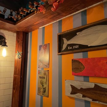 Porto Salvo - a bathroom with a tiled floor and colorful walls - Italian Near Me - Bronx, New York Porto Salvo - a bathroom with a tiled floor and colorful walls - Italian Near Me - Bronx, New York