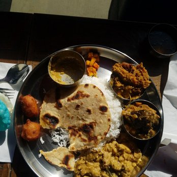 Southern Spice - Lunch Thali - rice/bread in the middle and 3 types of curries on the outside of the plate - Indian Near Me - Irving, Texas