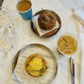 Swadesi Cafe - Samosa chaat croissant and pear cake (top), iced turmeric honey latte and masala chai - Bakeries Near Me - Chicago, Illinois Swadesi Cafe - Samosa chaat croissant and pear cake (top), iced turmeric honey latte and masala chai - Bakeries Near Me - Chicago, Illinois