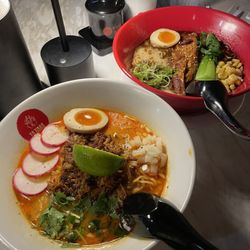 Tajima Ramen Crown Point - White bowl is carnitas ramen, red bowl is the black tajima ramen.