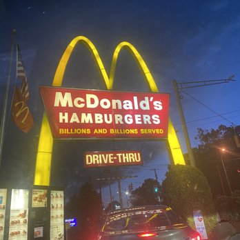 McDonald's - a car driving past a drive thru sign - Fast Food Near Me - Milford, Connecticut