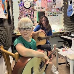 Danman's Music School - One of our students Raffa with his teacher Bianca learning the guitar