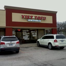 two cars parked in front of a restaurant two cars parked in front of a restaurant