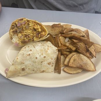 Yoli Kitchen - a breakfast burrito and chips on a plate - Mexican Near Me Yoli Kitchen - a breakfast burrito and chips on a plate - Mexican Near Me