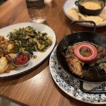 Tupelo Honey Southern Kitchen & Bar - Cast Iron Pork, Crispy Brussels, Rosemary & Parmesan Crispy Potatoes - Southern Near Me - Franklin, Tennessee Tupelo Honey Southern Kitchen & Bar - Cast Iron Pork, Crispy Brussels, Rosemary & Parmesan Crispy Potatoes - Southern Near Me - Franklin, Tennessee