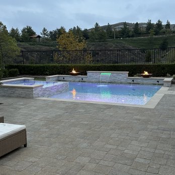 Waterfalls Etcetera - a pool and lounge chairs - Landscaping Near Me