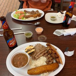 a plate of food and a bottle of beer