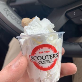 Scooter's Coffee - a hand holding a cup of ice cream - Coffee & Tea Near Me - Johnston, Iowa
