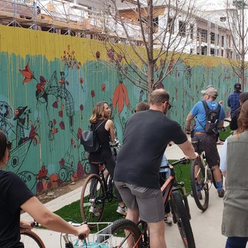Ride OKC - The temporary construction fence mural by Denise Duong was one of my favorite art stops on the tour! - Bike tours Near Me - Oklahoma City, Oklahoma Ride OKC - The temporary construction fence mural by Denise Duong was one of my favorite art stops on the tour! - Bike tours Near Me - Oklahoma City, Oklahoma