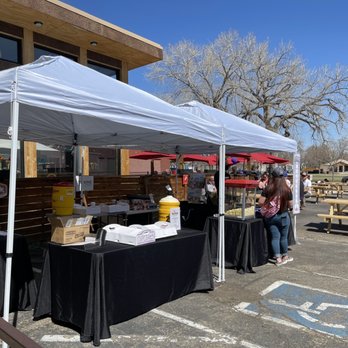 Monkey Barrel - a group of people standing under a tent - Bars Near Me - Denver, Colorado