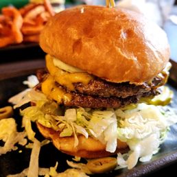 Burger w/ Garlic Mayo, Lettuce, Pickles, Green Olives and Cheddar Cheese. Burger w/ Garlic Mayo, Lettuce, Pickles, Green Olives and Cheddar Cheese.