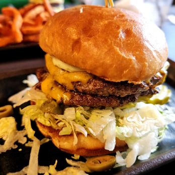 Basement Burger Bar - Burger w/ Garlic Mayo, Lettuce, Pickles, Green Olives and Cheddar Cheese. - American Near Me - Detroit, Michigan Basement Burger Bar - Burger w/ Garlic Mayo, Lettuce, Pickles, Green Olives and Cheddar Cheese. - American Near Me - Detroit, Michigan