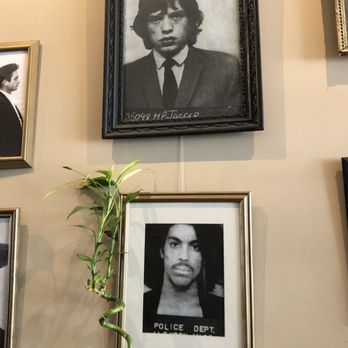 Mugshots - Two celebrity mugshots on the wall. - Cafes Near Me - Wheeling, West Virginia