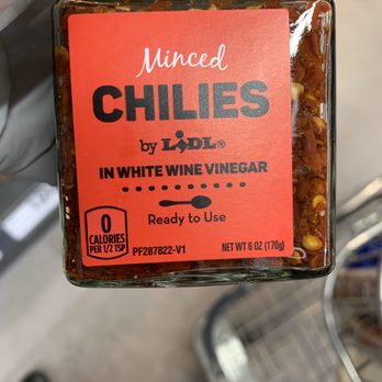 Lidl - a person holding a jar of chilis - Grocery Near Me - Nottingham, Maryland