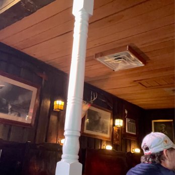 Mitch's Tavern - a man and a woman sitting at a table - Pubs Near Me - Raleigh, North Carolina