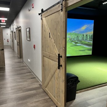 Golf Cove - a view of a golf course through a barn door - Golf Near Me - North Haven, Connecticut