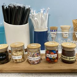 Tea World - Ice cream toppings (front), straws, and ice cream cone sizes and prices